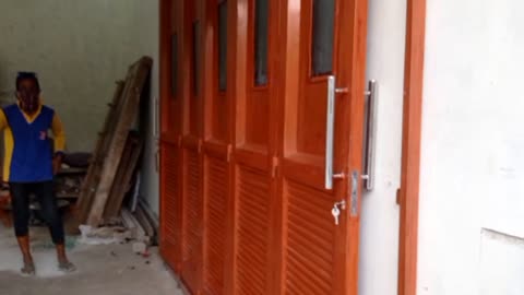 Welder tests the iron door made by him