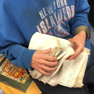 New york islanders blue sweater guy sifting through old book pages