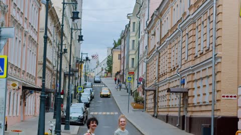 A Couple Crossing a Road with their Dog