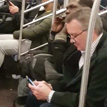 Guy uses scissors to trim beard on subway
