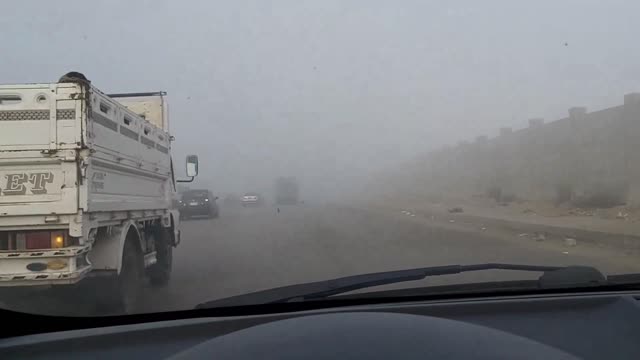 Fog on the oases road in front of the pyramids