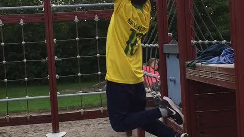 Yellow shirt kid falls off monkey bars