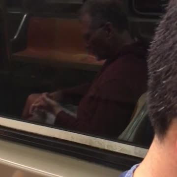 Man in red sweater clipping finger nails