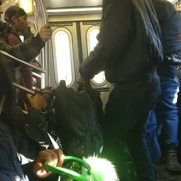 Two guys black jackets fighting on subway train