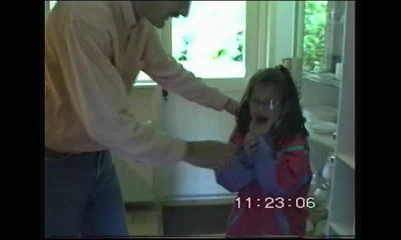 Little girl making hilarious and heartbreaking faces after father pulls her fore tooth out