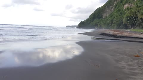 waves breaking on black sand beach