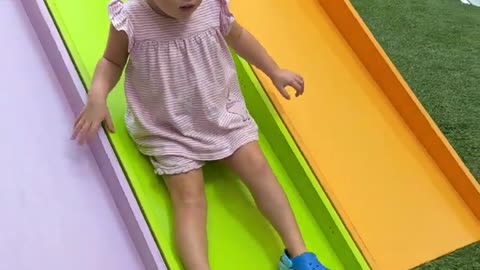 Naomi on the playground. Funny toddler is playing!