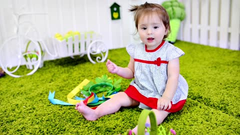 Little girl playing on the carpet