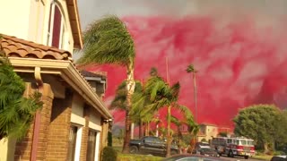 Plane drops fire retardant over neighborhood homes in California