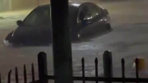 Person Witnesses Car Stuck In Middle Of Flooded Street While Being Stranded Inside Bar