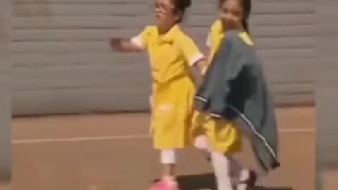 This girl shows her prosthetic leg to her schoolmates