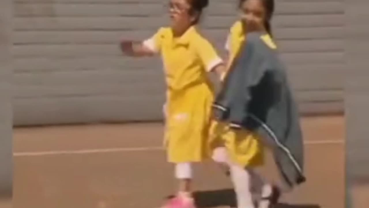 This girl shows her prosthetic leg to her schoolmates