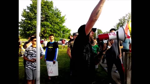 Mr. Freedom sings the national anthem with fellow patriots.