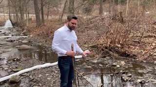 JD Vance visits a creek flowing near East Palestine