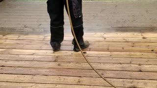 Hard work power washing a deck for stain