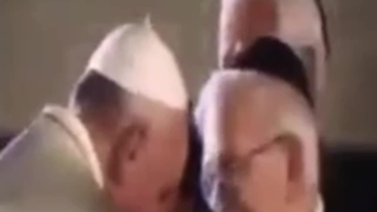 What’s going on here? the pope is kissing the hands of who?