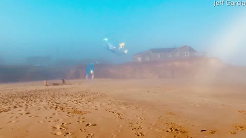 Gigantic Soap Bubble Blown Under White Rainbow