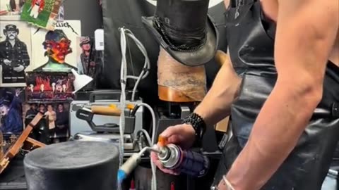 Guy Creating a custom made dusty top hat.