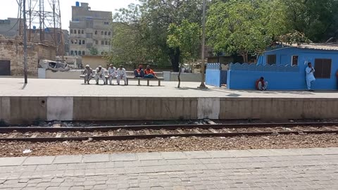 Sunny afternoon at Drigh road station, childrens play and wait for the tezgam TRAIN....