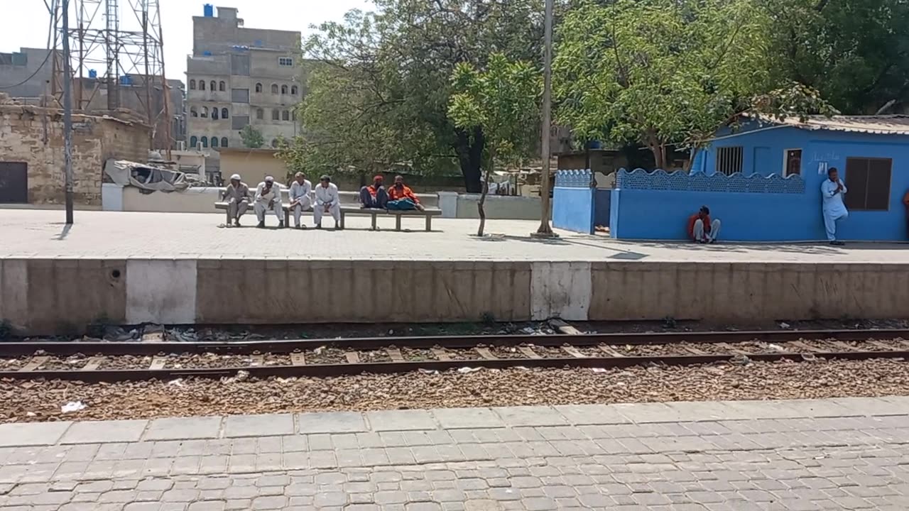 Sunny afternoon at Drigh road station, childrens play and wait for the tezgam TRAIN....