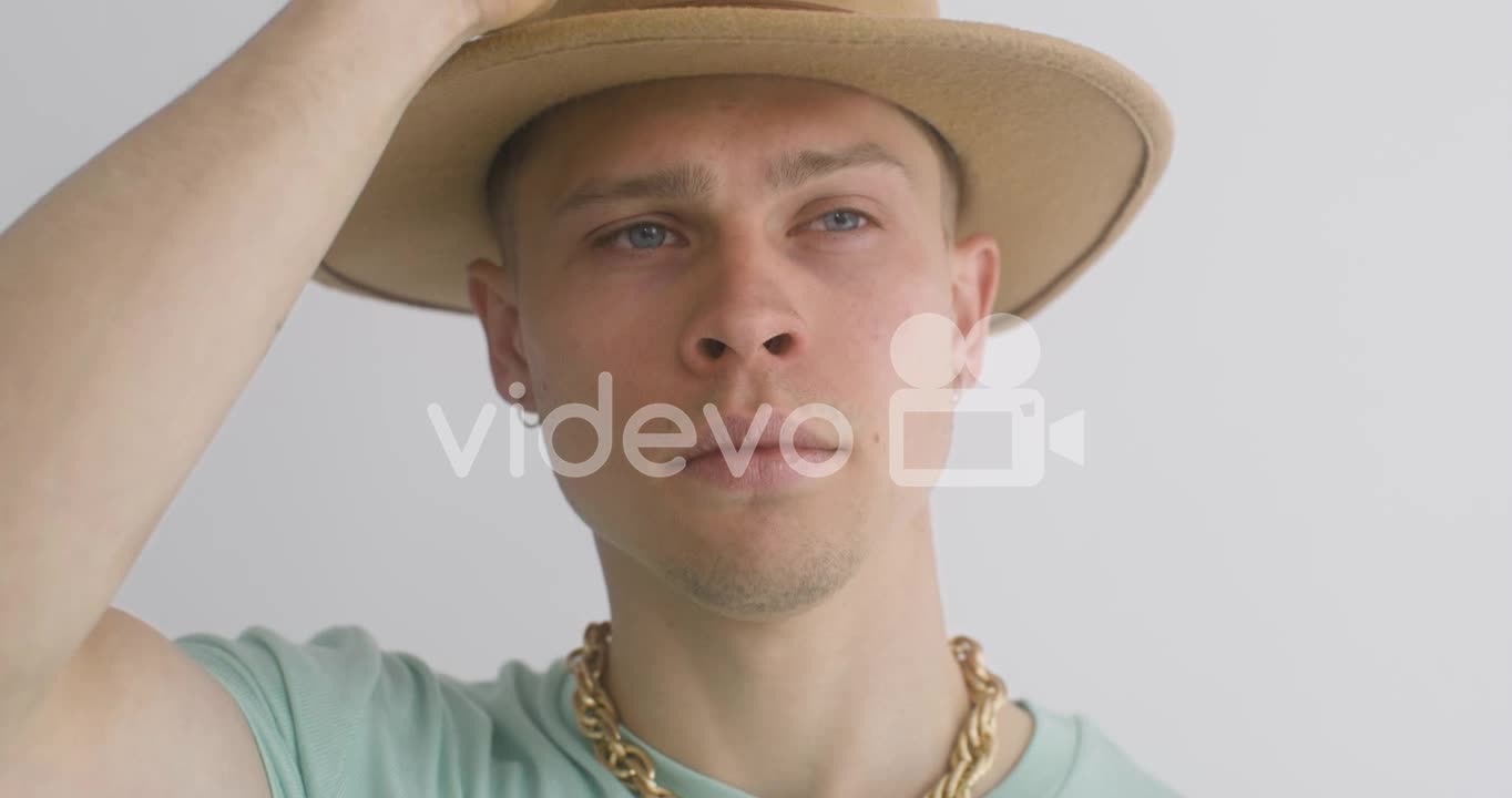 Portrait Of Young Man Putting A Hat On, Looks At Front And Then, Moves His Head 2