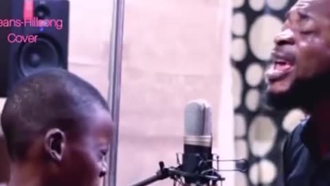 Father and son sing together