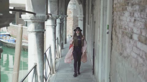 Woman walking in the canal of Venezia