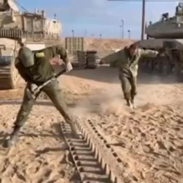 Israeli Soldier Hammering Tank Treads Together