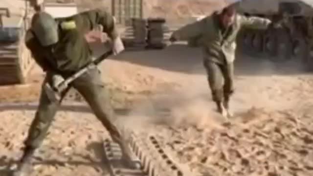 Israeli Soldier Hammering Tank Treads Together