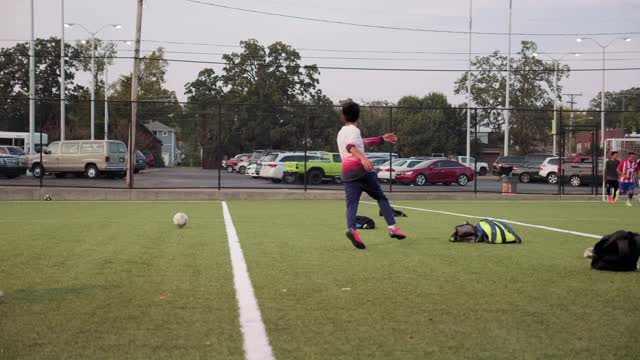 group of boys plays soccer in a soccer field