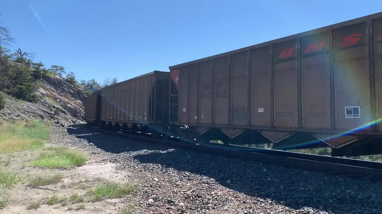 Solid EMD SD70ACe lineup up Mullan Pass. 3 BNSF, 4 MRL, then 1 BNSF on the rear.