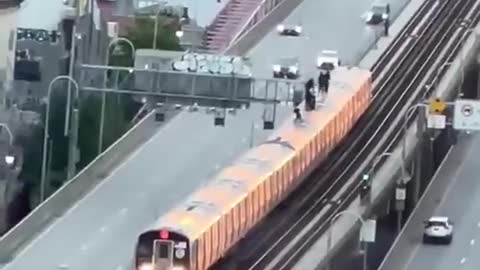 NYC: Williamsburg Bridge, watch as a group of people are on top of a moving train in Brooklyn.