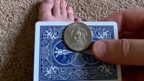 Getting a quarter to standup on its edge on a playing card.