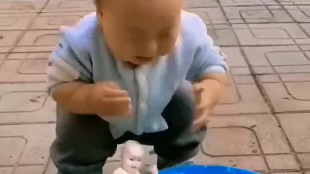 baby playing with fish.