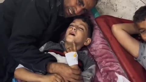 A desperate father tries to comfort his son undergoing a painful amputation