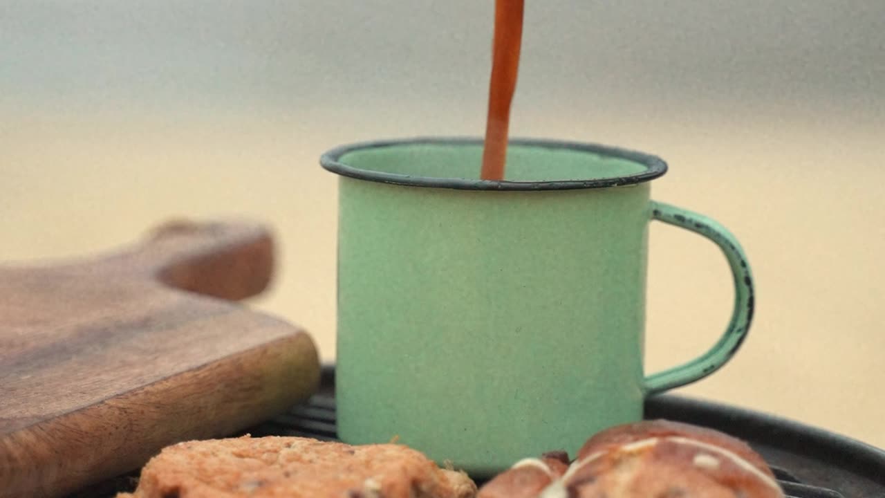 A Person Pouring Hot Coffee in a Cup