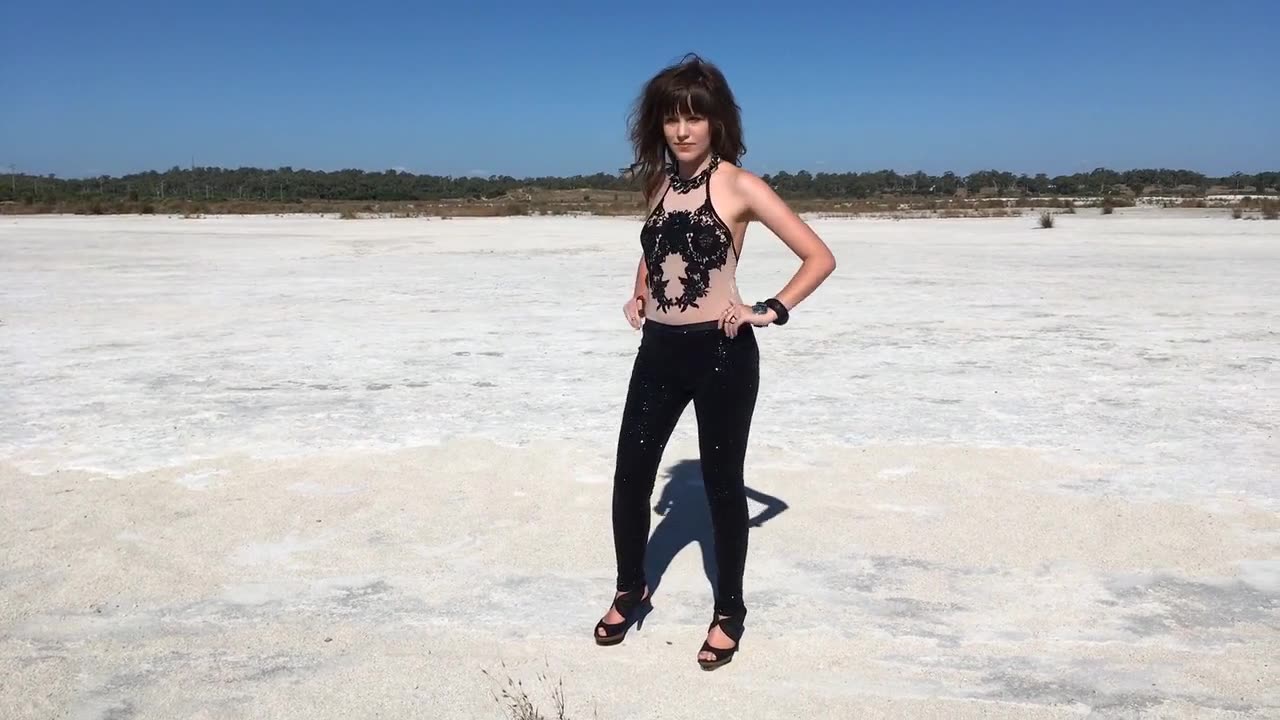 Girl walking on the outback with high heels