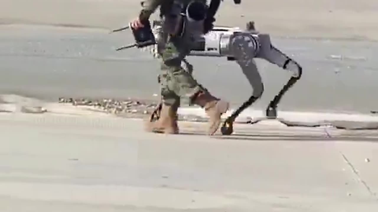 Chinese People’s Liberation Army soldier can be seen walking with an armed robot dog