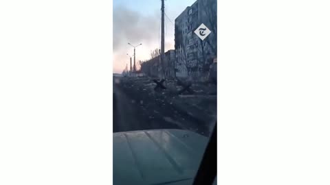 Ukrainian soldier drives truck through burning ruins of Bakhmut