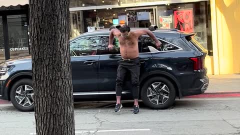 Wild Man Punching and Climbing on Cars Gets Arrested