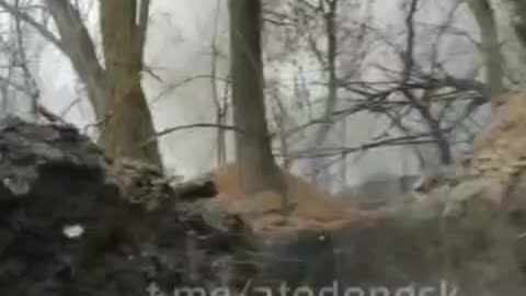 Ammunition burns inside a Ukrainian trench
