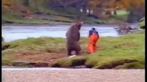 A Man Fighting Over a Fish With Bear