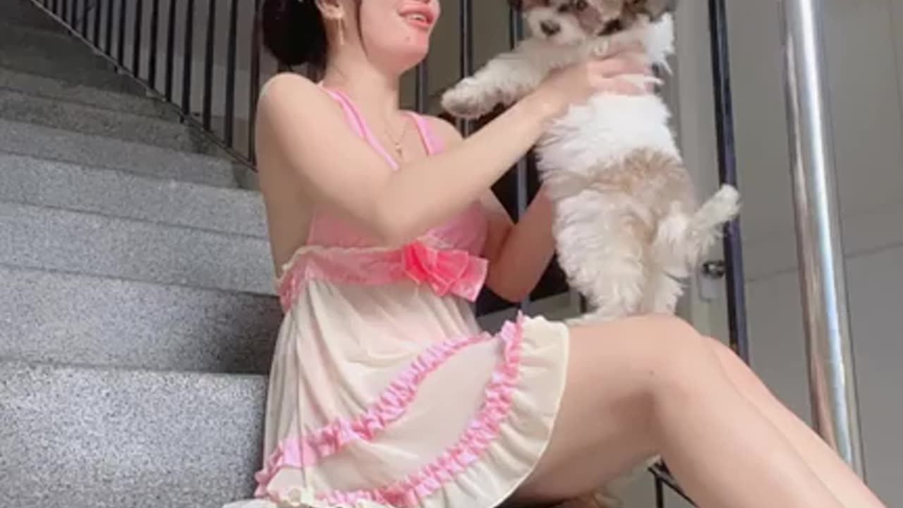 Girl and cute baby dog playing game