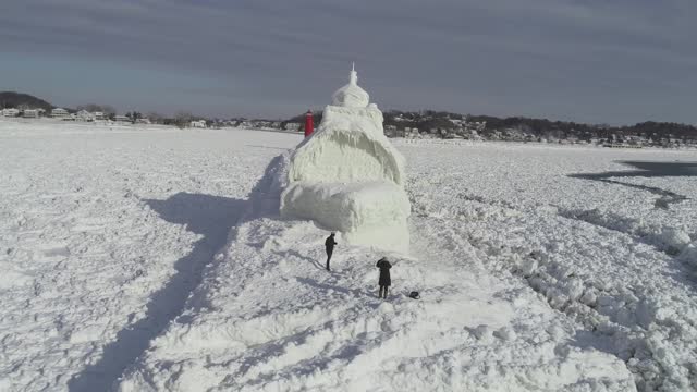 Drone Hovers Around Frozen Boat-Shaped Lighthouse