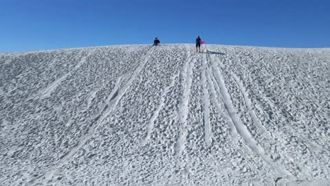 A race down the sand slopes, girth wins out.