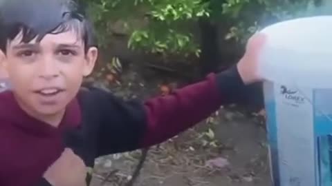 Palestinian kid expresses his joy as he collects rainwater in Gaza