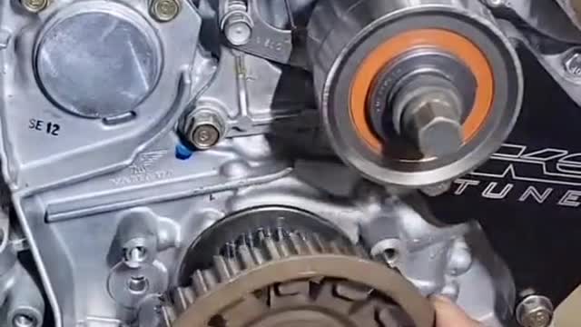 The repairman installs car engine gadgets