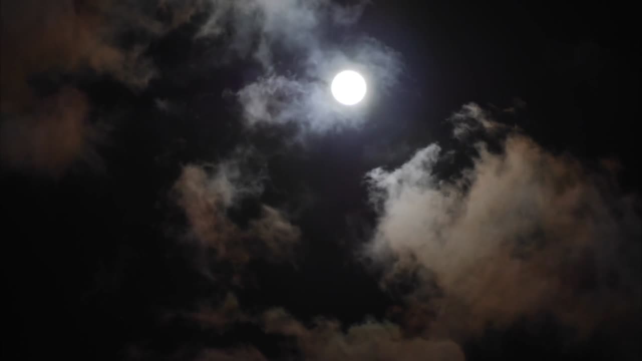 Calm moon in cloudy sky