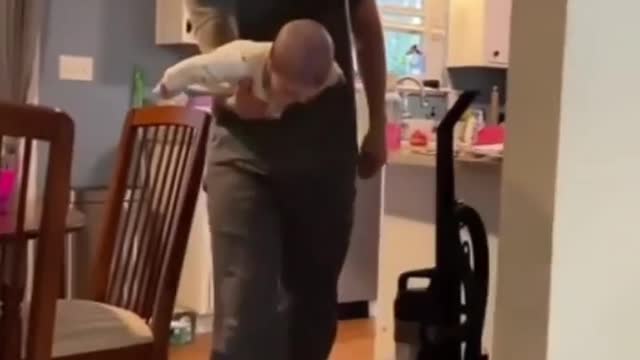 father helping his baby to fly