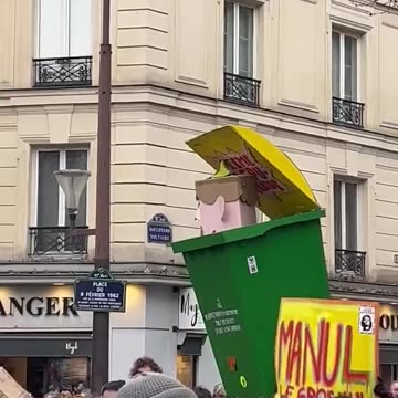 A demonstration in France with "Macron" in the bin